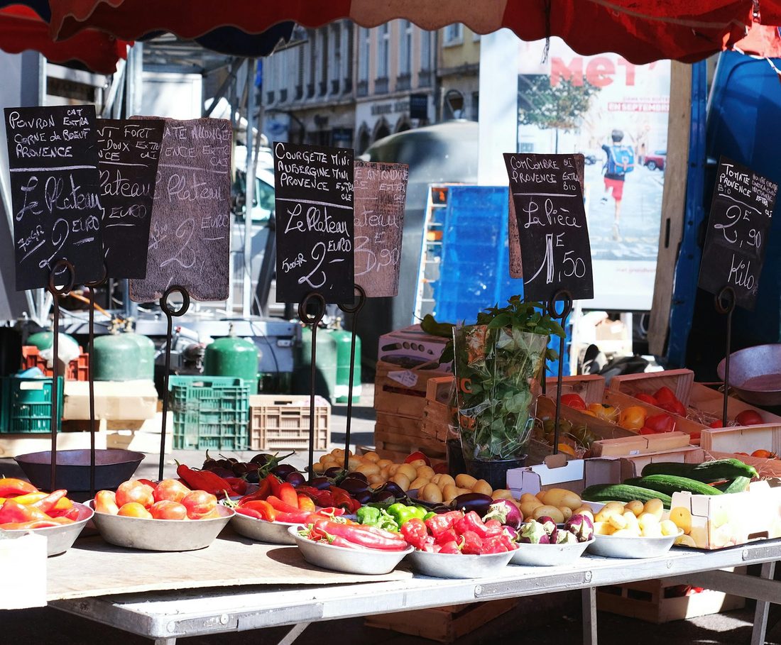 Marktkraam met verse groenten en handgeschreven krijtbordjes met prijzen